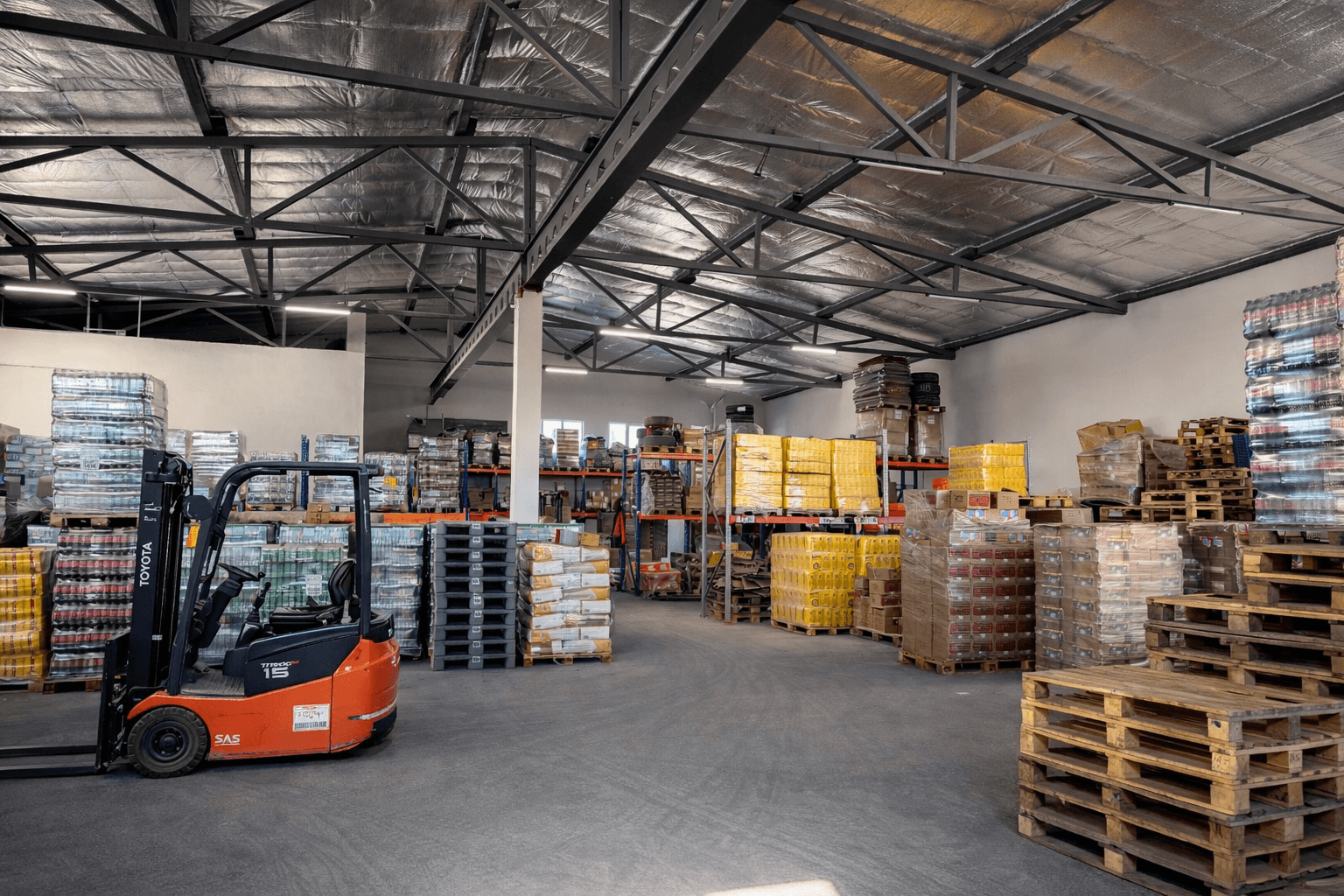 Warehouse with beverage pallets and forklift